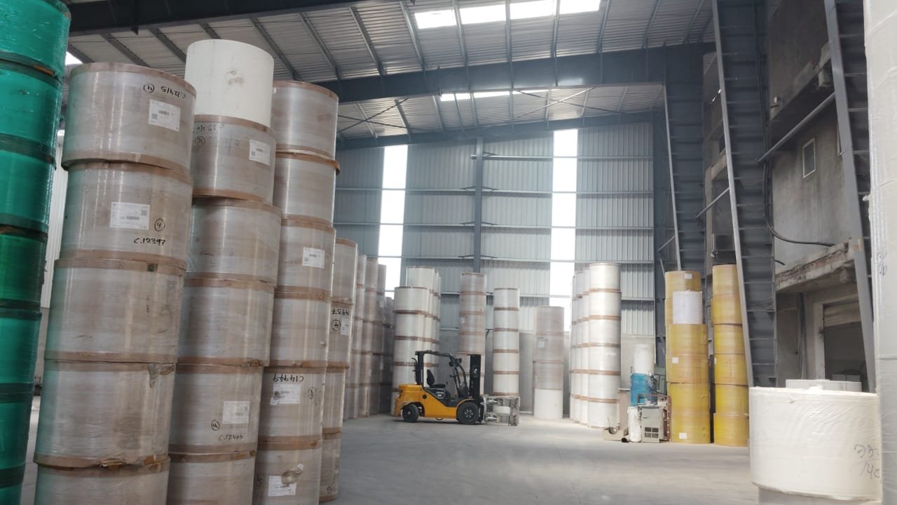 Stacked paper reels in the raw material warehouse