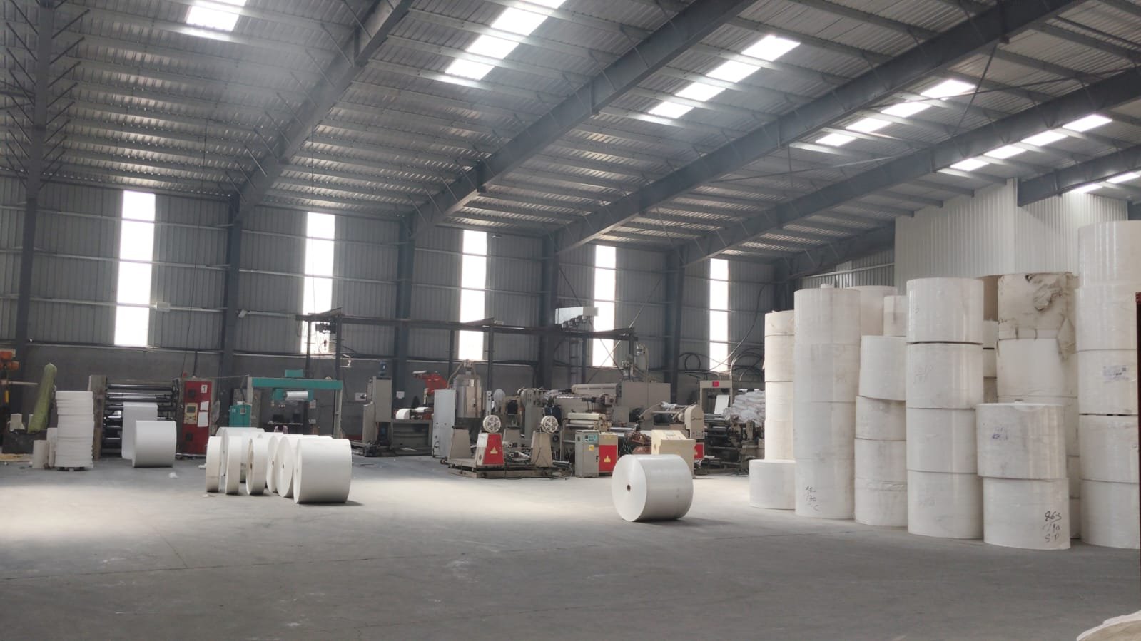 Paper reels inside the Aaradhya Disposal Industries manufacturing hall in Dewas
